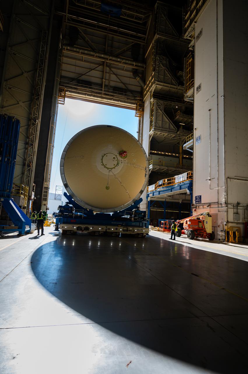 Technicians transported the assembled upper part of the Artemis II core stage to the final assembly area inside the factory at NASA’s Michoud Assembly Facility in New Orleans.  On Jan 10, the forward assembly, left was moved next to the Artemis II liquid hydrogen tank, which has been undergoing assembly. Next, Boeing, the lead core stage contractor, will join the forward assembly and the liquid hydrogen tank to complete most of the core stage for the Space Launch System (SLS) rocket that will send the first crew on an Artemis mission. The core stage consists of five major structures that are built, outfitted, and then connected to form the final stage. The forward skirt, liquid oxygen and intertank were connected and tested to form the 66-foot forward assembly. After the forward assembly is joined with the 130-foot liquid hydrogen tank, only the engine section, the fifth piece of the stage, will need to be added to complete the Artemis II core stage.  The core stage serves as the backbone of the rocket, supporting the weight of the payload, upper stage, and crew vehicle, as well as the thrust of its four RS-25 engines and two five-segment solid rocket boosters attached to the engine and intertank sections. On Artemis II, the SLS rocket will launch the Orion spacecraft and a crew, sending them into lunar orbit, in preparation for later Artemis missions that will enable the first woman and first person of color to land on the Moon.